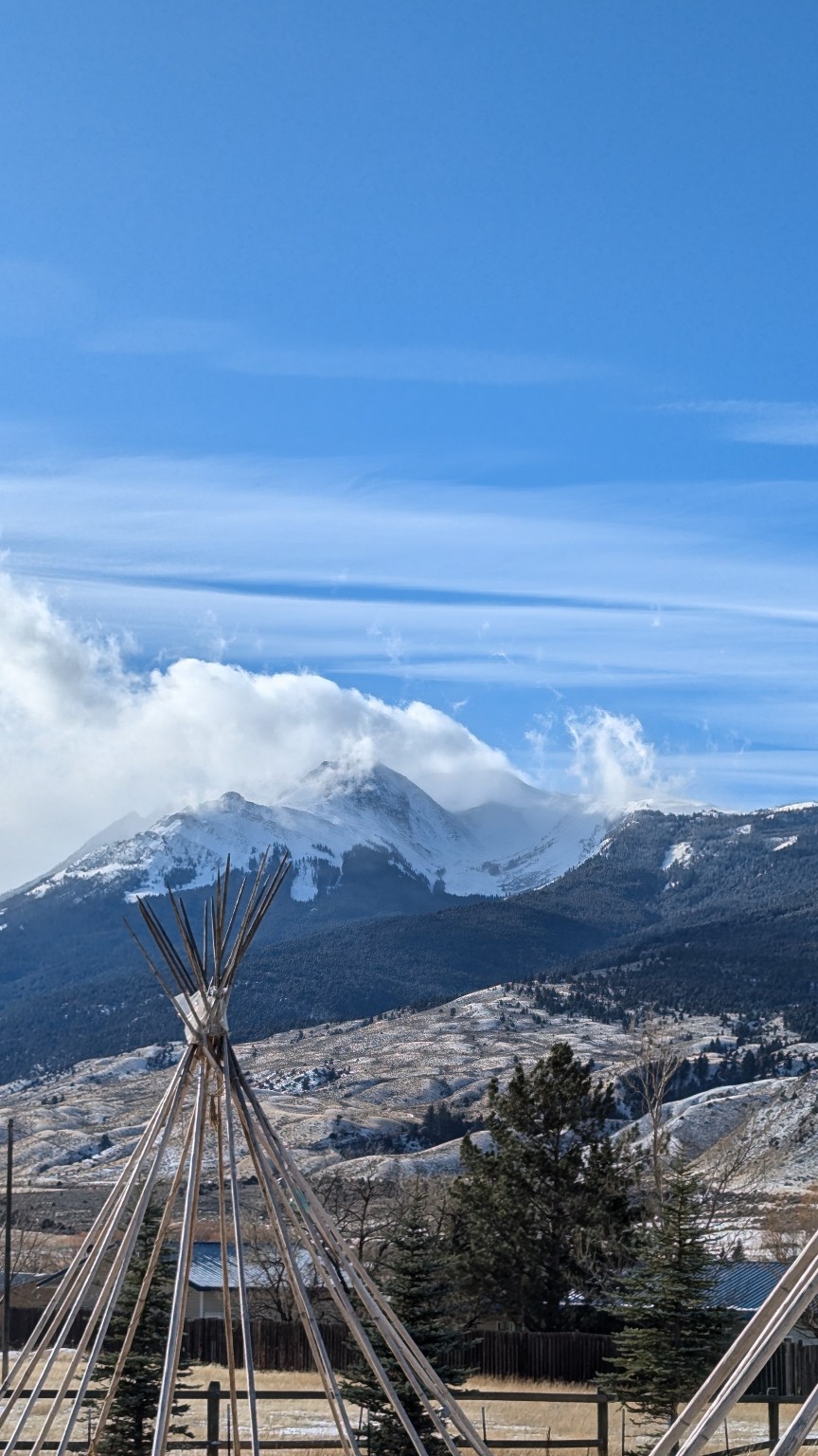 Teepee and snowy mountain